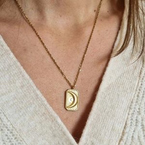 Gold stainless steel necklace featuring a rectangular pendant with moon and rays pattern