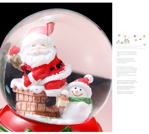 Detailed close-up of Christmas crystal ball with Santa Claus and snowman inside