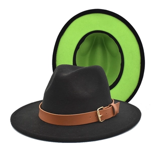 Detail of black fedora hat showing contrast neon green lining and brown leather band