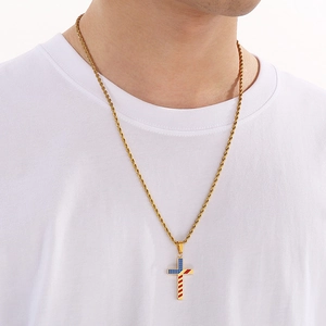 Golden rope chain necklace with a US flag patterned cross pendant worn by a model