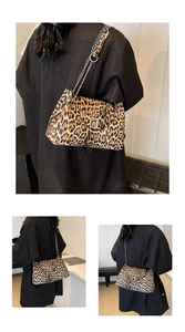 Detailed views of leopard print crossbody bag with gold chain strap on black coat