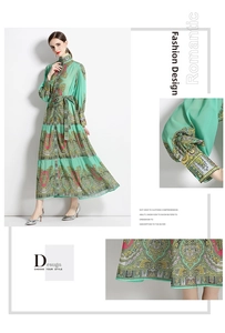 Détail d'une robe longue fleurie vert menthe avec motif baroque et jupe à plusieurs niveaux