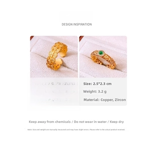 Detailed macro view showing the 24k gold-plated floral and emerald vintage style rings