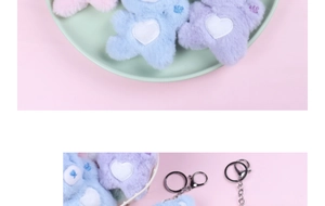 Close-up of colorful plush bear keychains in pink, blue, and purple with heart patterns