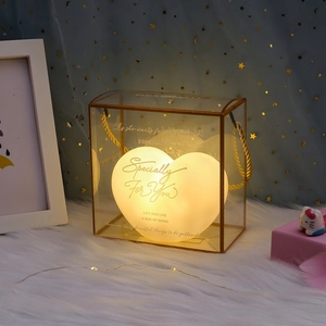 Romantic heart-shaped night light in a gold-framed gift box with warm yellow lighting
