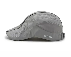 Detail view of grey quick-dry mesh cap showing side sports text and breathable texture