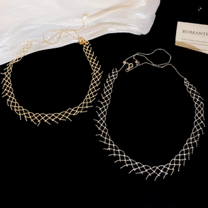 Detail of woven mesh texture necklaces in gold and silver finish with wavy edges