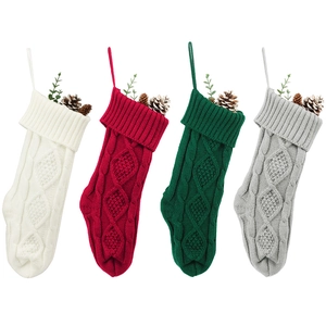 Close-up of cable knit Christmas stockings in white red green and gray with hanging loops