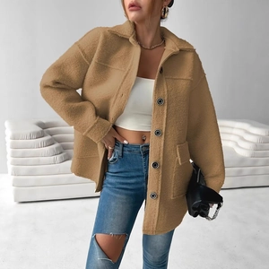 Detailed texture of khaki faux fur jacket featuring large black buttons and deep pockets