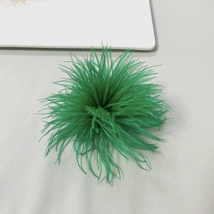 Detailed view of emerald green ostrich feather brooch with soft velvet-like texture