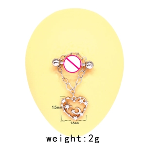 Detail showing heart-shaped silver nipple ring with moon and star pattern on a model