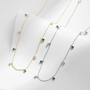 Elegant S925 silver fringe necklace with emerald green stones and white cubic zirconia