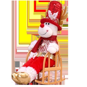 Detailed side view of Christmas reindeer plush doll with red sequins on a rocking chair