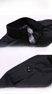 Detail view of the black jacket stand collar with ribbed stitching and shoulder strap