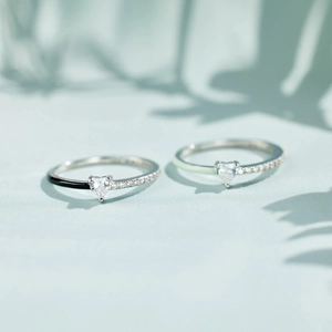 Detailed macro view of S925 silver rings with heart stones and colorful enamel bands