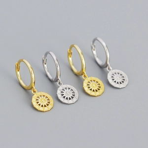 Detailed close-up of S925 silver star compass earrings in gold and silver finishes