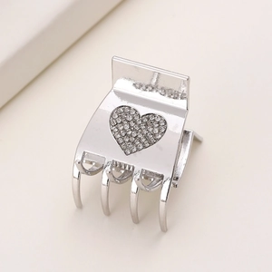 Elegant silver metal hair claw clip with sparkling rhinestones in a heart shape design