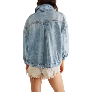Detailed back view of oversized blue washed denim jacket with structured stitching details