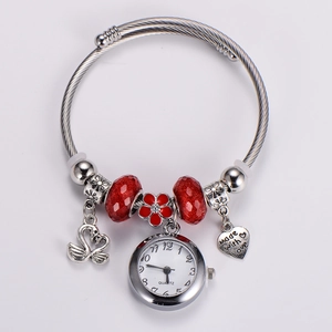 Close-up of adjustable steel wire bracelet with swan pendant and red beads with quartz watch