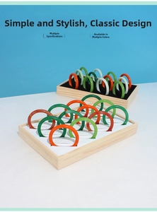 Solid wood jewelry tray displaying various colorful resin bangles with a smooth finish