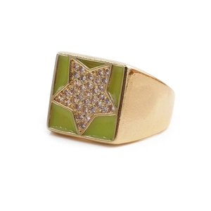 Detail of gold star ring featuring green enamel and shimmering zircon inlay crystals