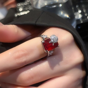 Macro shot of silver ring with luxury square cut red ruby and pave diamond details