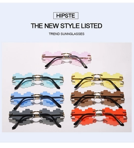 Flat lay of pixel-style heart sunglasses in seven vibrant colors on white background