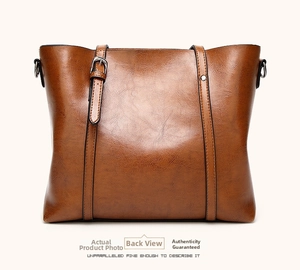 Rear view of brown faux leather bucket bag with litchi grain and silver buckle