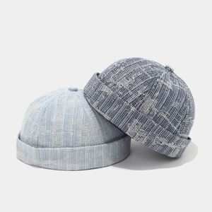 Detail of stacked blue washed denim miki hats showing retro brimless crown and woven texture