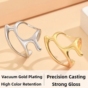 Macro view of fluid irregular stainless steel rings in polished gold and silver finish