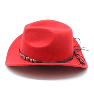 Detail of red cowboy hat featuring ethnic woven band and metallic rivet accents