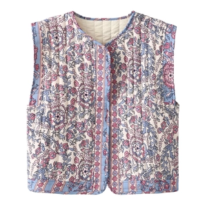 Detail of V-neck quilted vest showing floral print texture and fine stitching