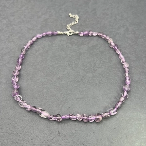 Detail showing natural amethyst irregular stones on a stainless steel chain necklace