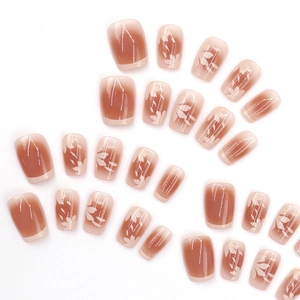 French ombre press-on nails with white leaf art patterns in nude and coffee gradient