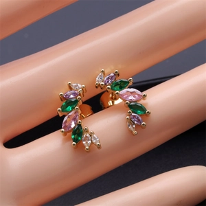 Macro detail of gold-plated geometric flower earrings with colorful marquise-cut zircons