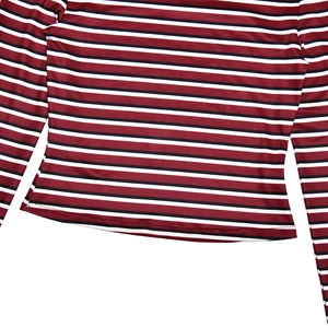 Detailed close-up of red and black striped fabric with hem stitching and elastic texture