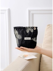 Elegant black butterfly embroidery cosmetic bag with texture and golden petal zipper