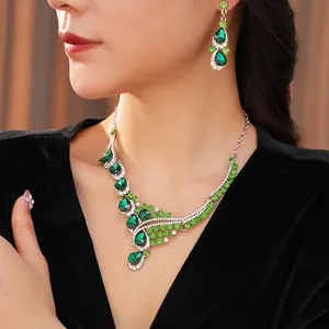 Vintage teardrop jewelry set with green crystals including a necklace and earrings