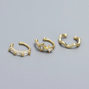 Three gold-plated S925 silver ear cuffs featuring sparkling crystals and geometric designs
