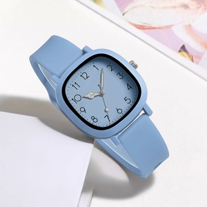 Detail of light blue square watch with silicone strap and numeric markers on white background