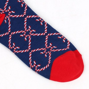 Detail of dark blue Christmas socks featuring red and white candy cane heart patterns