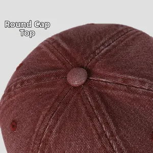 Close-up of the round crown and fabric texture on a washed denim baseball cap