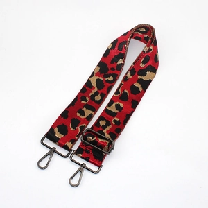 Adjustable leopard print wide bag strap with red and gold jacquard and gunmetal buckles