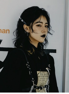 Detailed view of punk black hoodie with vintage spell patch and metal chain body harness