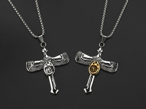 Detailed macro view of vintage eagle cross pendants in silver and gold finishes