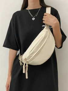 Minimalist off-white canvas crossbody chest bag with adjustable strap and ball pendant