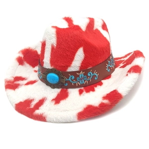 Detail of red cow print cowboy hat featuring blue turquoise inlay and floral embroidery