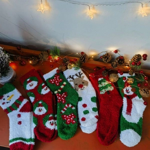 Cozy Christmas coral fleece socks set featuring holiday patterns like reindeer and Santa