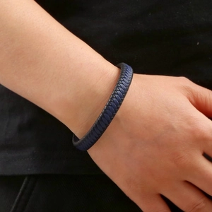 Detail of navy blue braided leather bracelet with magnetic clasp on a male wrist