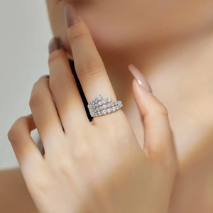 Close-up of a multi-layer S925 silver ring with zircon hearts on a model's finger